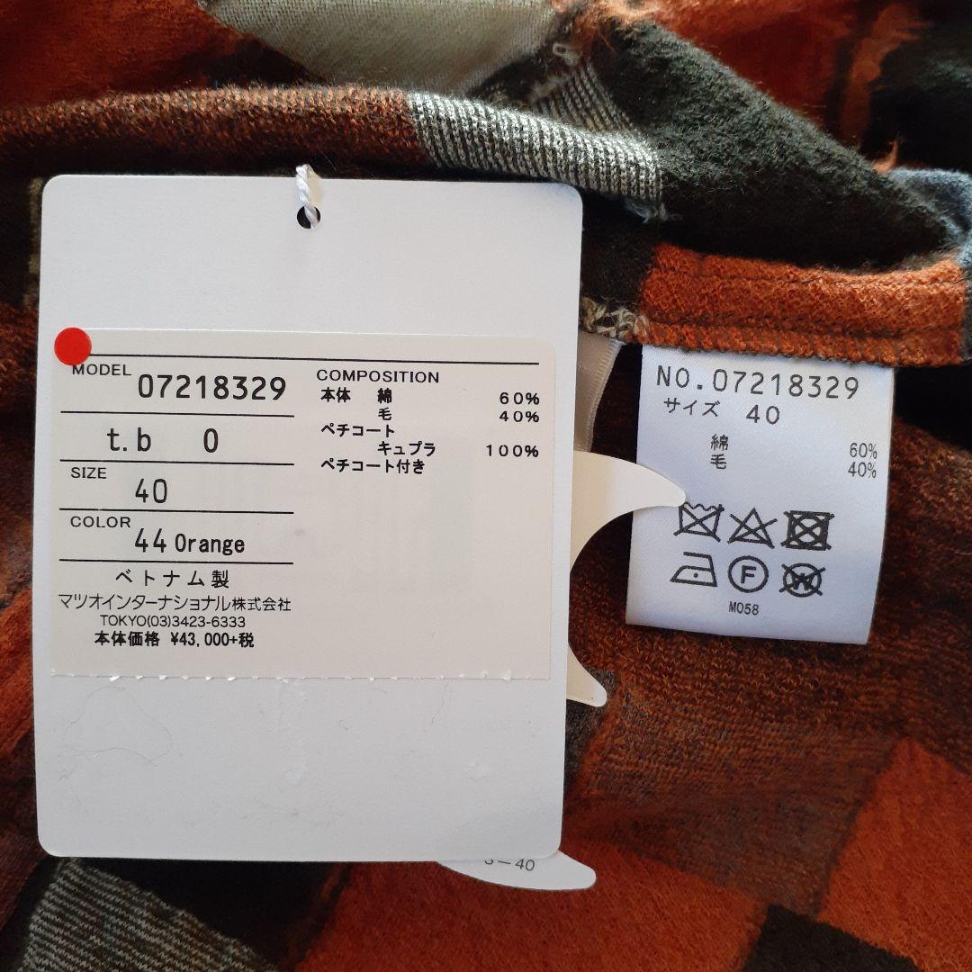 センソユニコ　オレンジ・黒・白のパターン長袖ワンピース