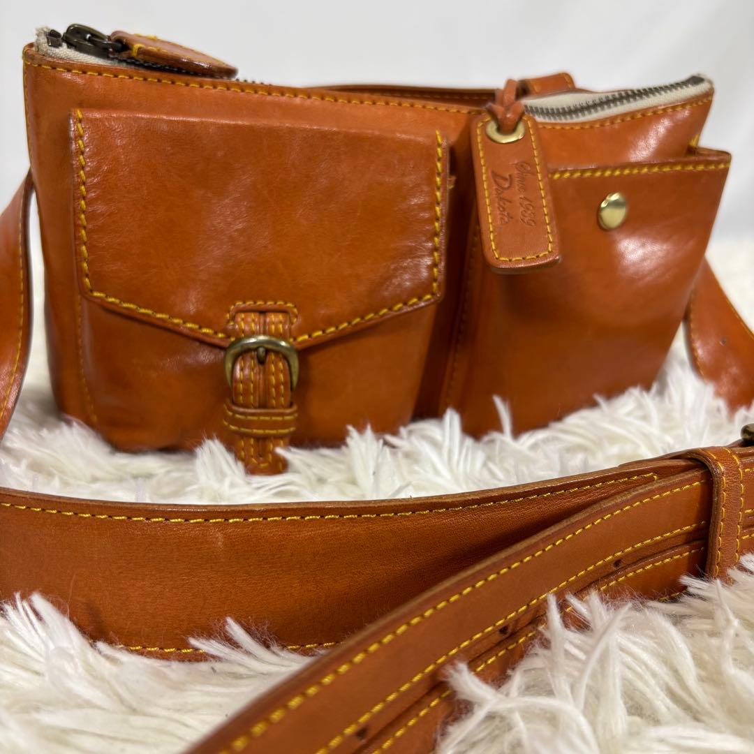 ダコタ ボディバッグ 斜め掛け 肩かけ ロゴ型押し ヌメ革 ベルト ユニセックス