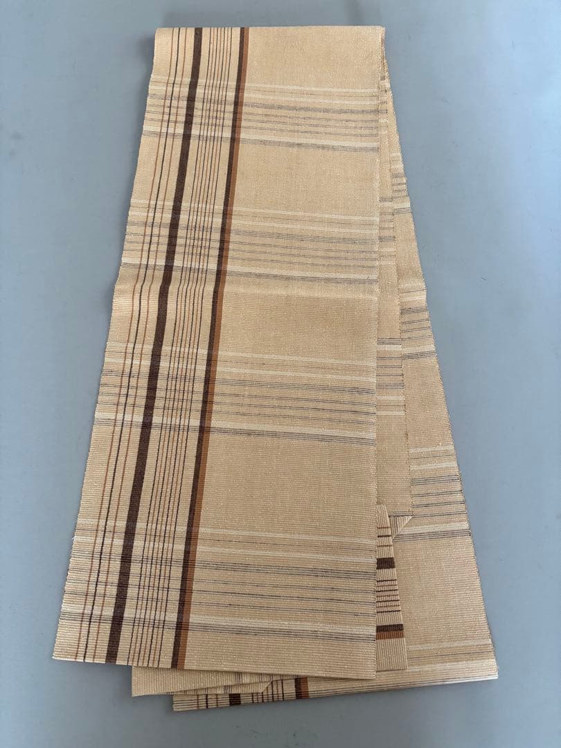 〈お楽しみ価格〉正絹 真綿紬 八寸名古屋帯 薄辛子ベージュ 変わり格子絣